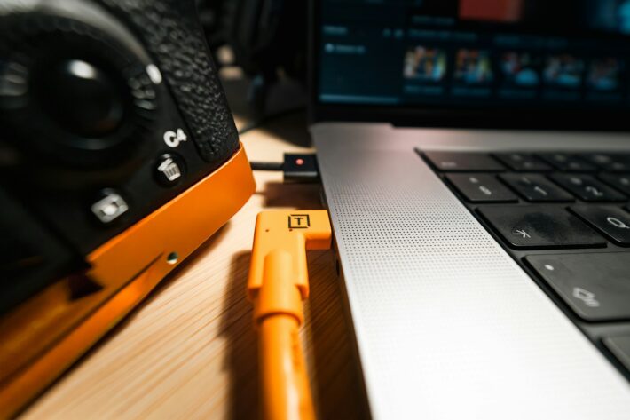 A laptop computer sitting on top of a wooden desk